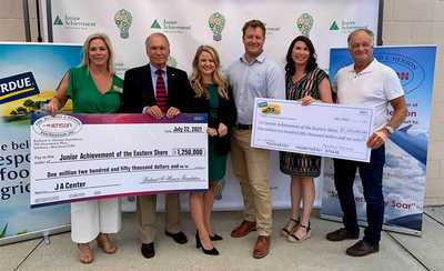 Six people standing holding a check for $1.25 Million