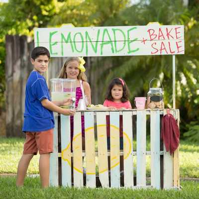 A group of children create a lemonade stand.